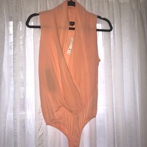 BEBE Deep plunge silk body suit.